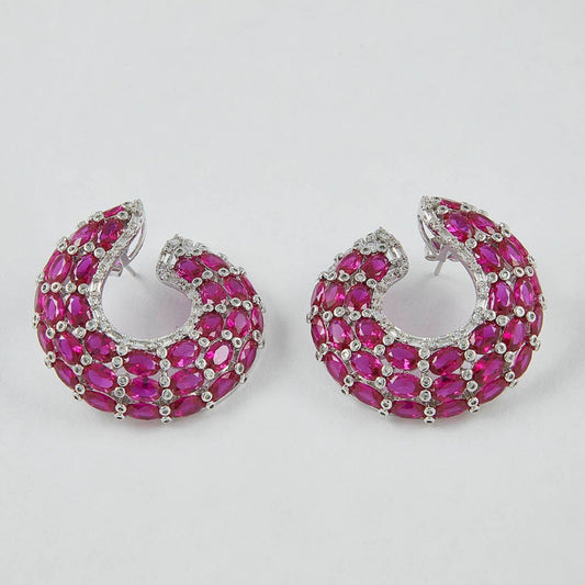 Pair of pink hoop earrings on a light gray background