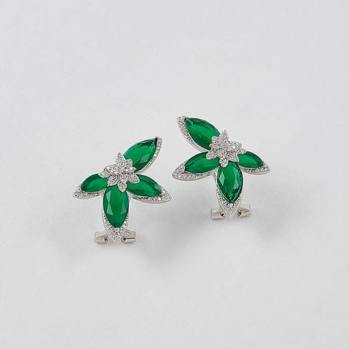 Pair of green and silver earrings on a white background