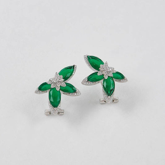 Pair of green and silver earrings on a white background