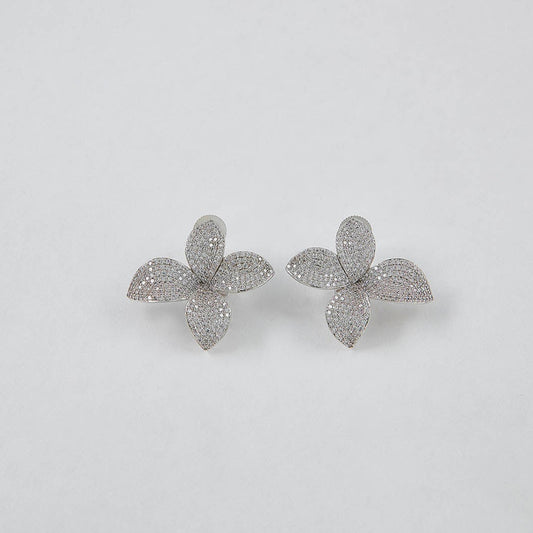 Flower-shaped earrings on a light gray background
