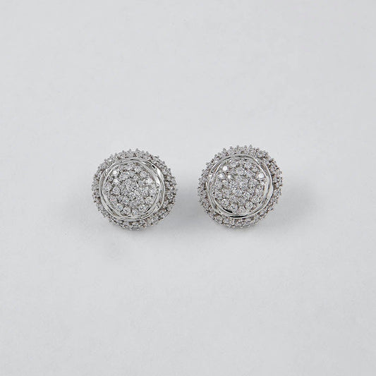 Pair of silver earrings with gemstones on a light gray background