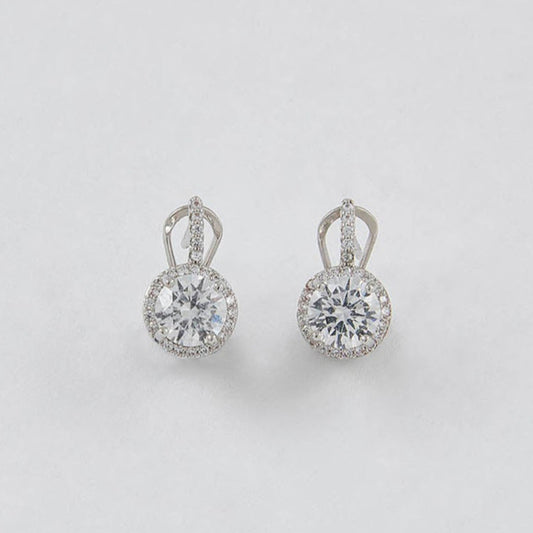 Pair of silver earrings with clear gemstones on a light gray background