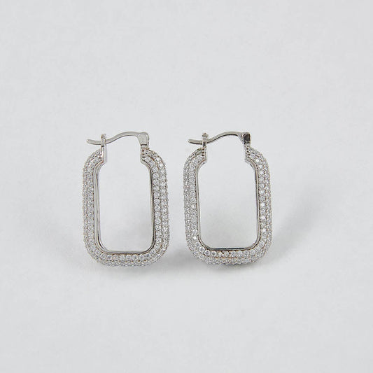 Pair of silver hoop earrings on a light gray background
